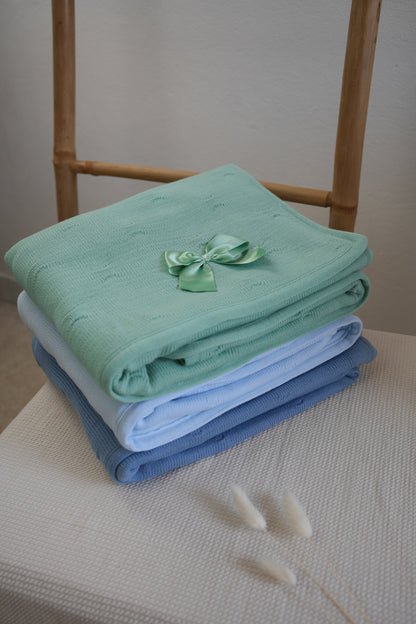 Embroidered knitted blanket with pompom