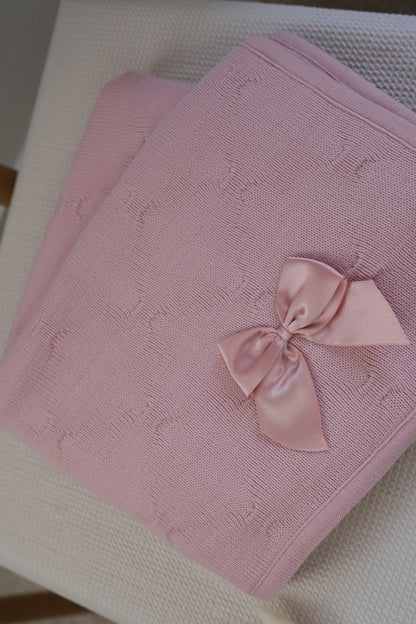 Embroidered knitted blanket with pompom