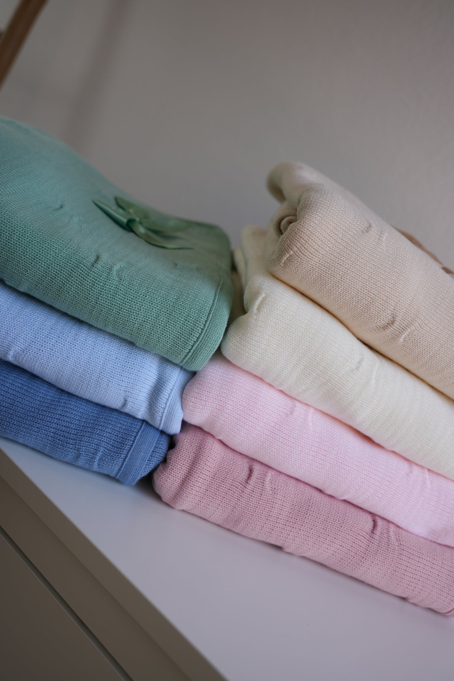 Embroidered knitted blanket with pompom