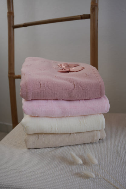 Embroidered knitted blanket with pompom